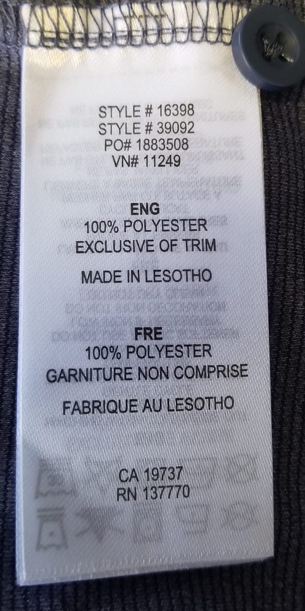 Sewn-in care label of an Elevate polo showing STYLE # 16398